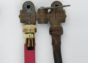 Two washer hoses, one of them a heavy duty hose, next to an old, rusty rubber washing machine hose.
