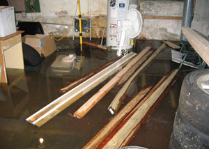 A severely water damaged home in West Haven, with lumber and personal items floating in a foot of water